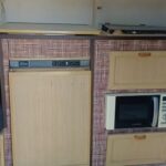 1992 Sprite Sport — kitchen with fridge, microwave and two-plate stove